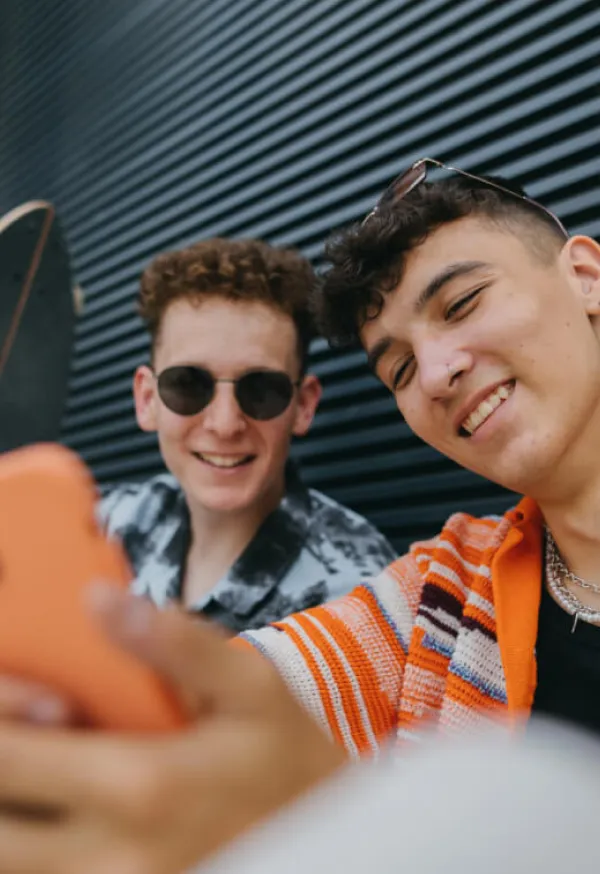 Un par de jóvenes felices tomando una selfie con su celular.