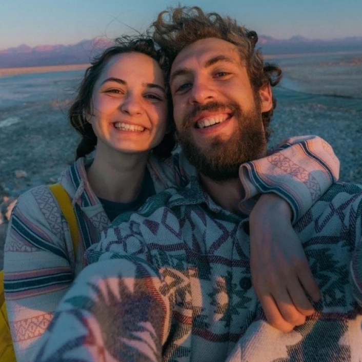 Dos personas disfrutando un viaje juntas al aire libre, compartiendo un momento de conexión, aventura y experiencias memorables.